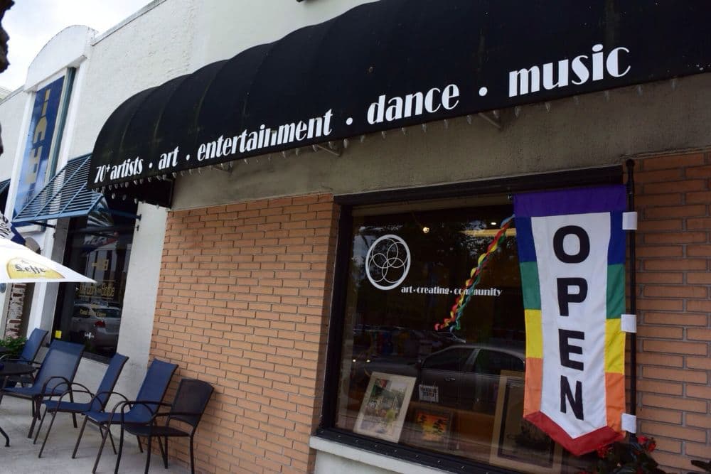 Art studio and community space with an "OPEN" banner and a focus on artists and entertainment.