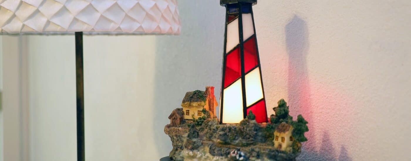 Red and white stained glass lamp on a white side table