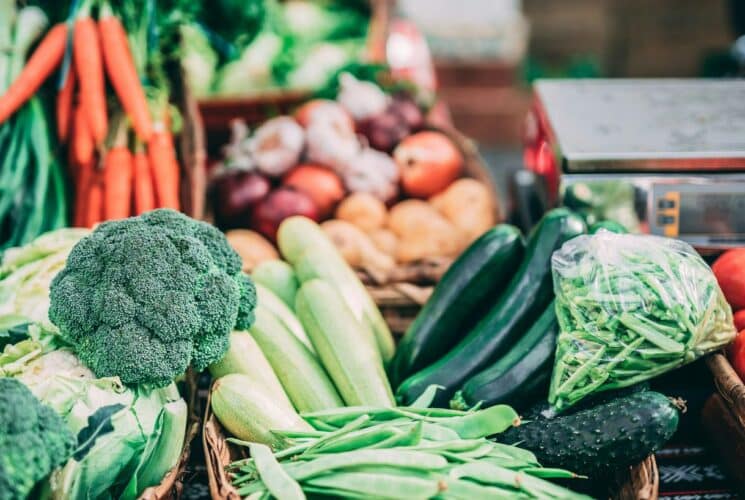 A table full of fresh green, red and orange vegetables